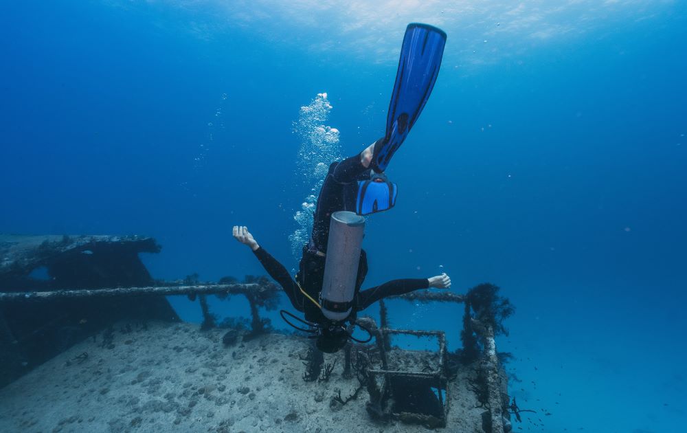 a scuba diver in wrecked ship