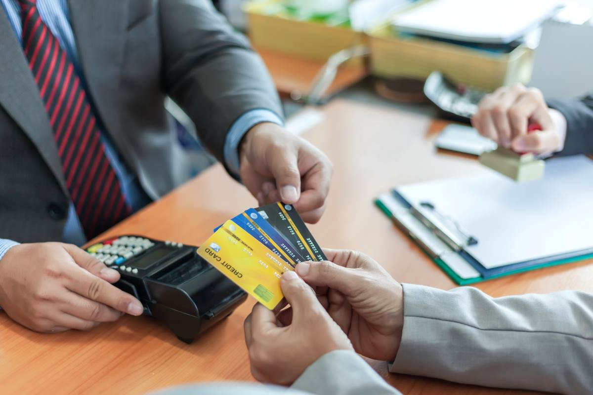 business man holding a gorup of business credit cards