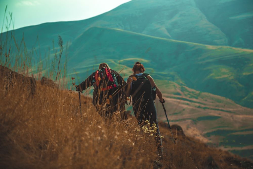 two peoples trekking together