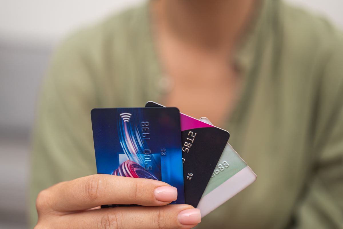 a woman holding a group of credit cards