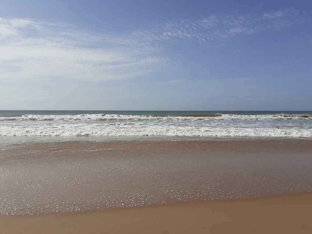 An Indian fisherman looks towards the Bay of Bengal, as he walks on boats  on the shore at Mypadu beach in Nellore district of Andhra Pradesh, 675  kilometers (421 miles) from Hyderabad,