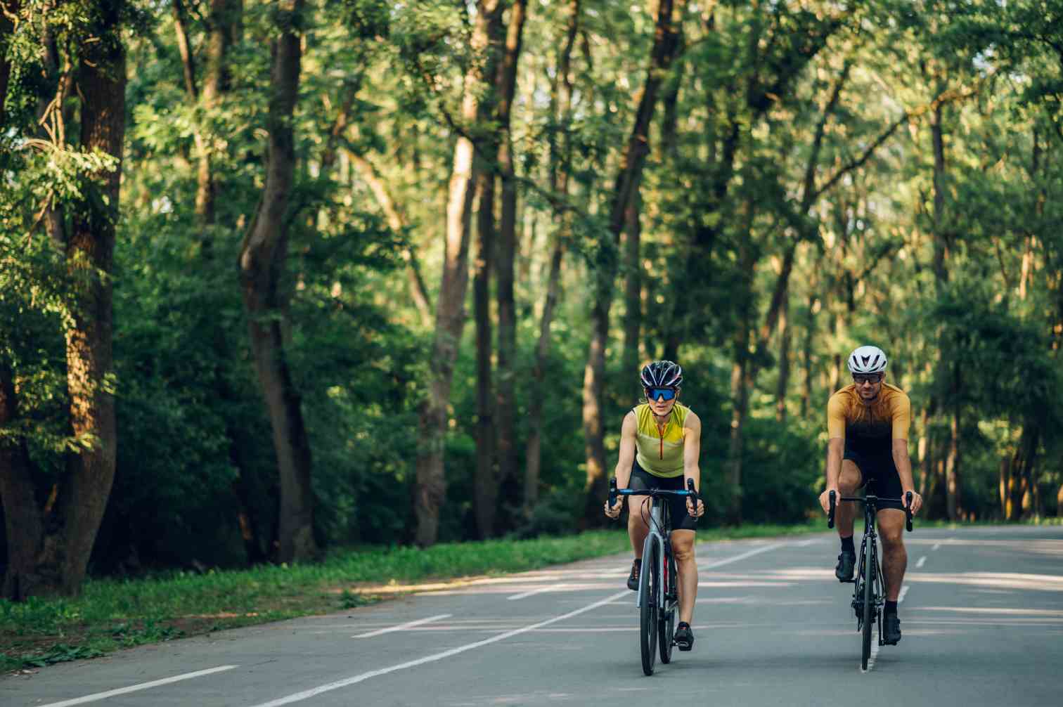 couple riding bicycles outside of the city