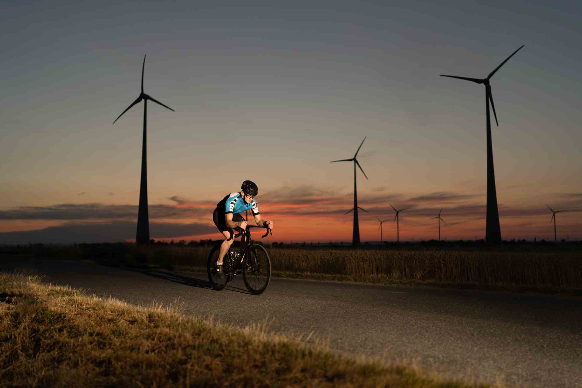 cyclist on the racing bike at sunset