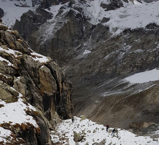 peoples trekking in snow covered area