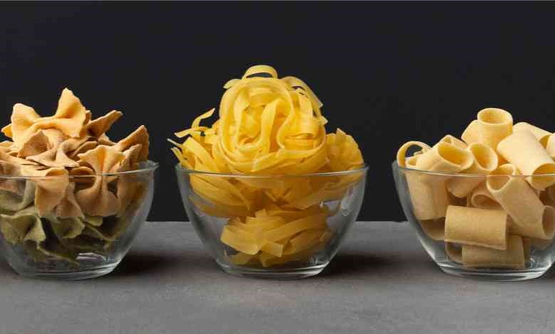 different shape pasta with carbohydrates on black