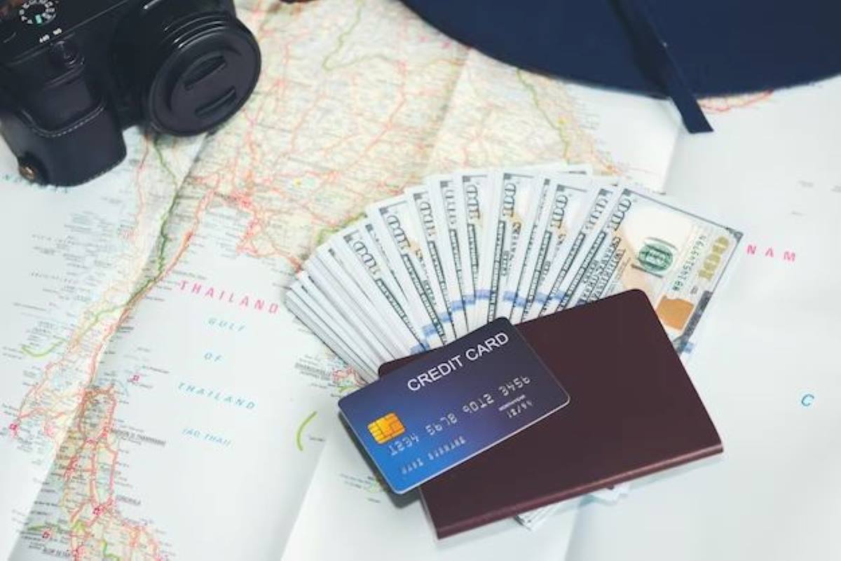 travel credit card placed along with the dollar bank notes and camera