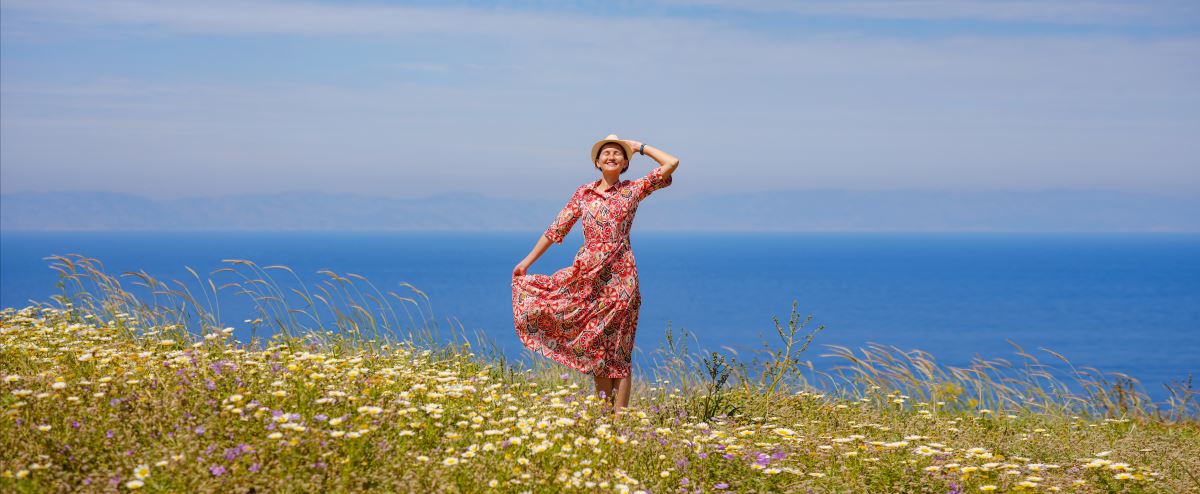 a girl with hat on hill