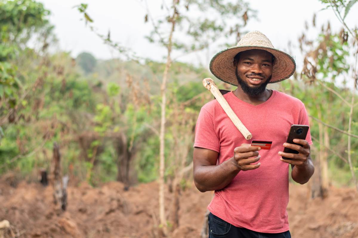 african farmer opening a farmers bank savings account through mobile