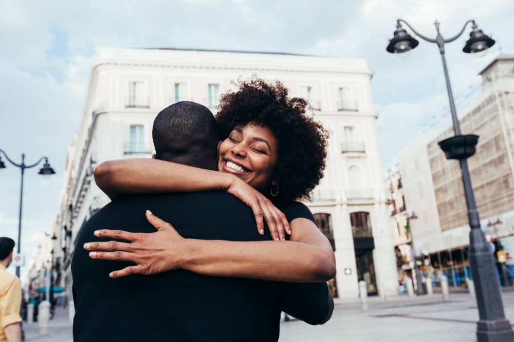 couple hugging at street