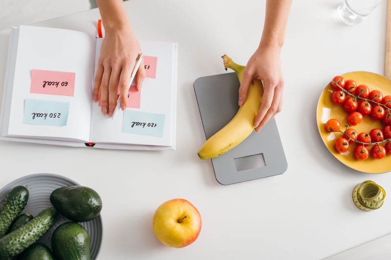 girl putting banana on scales