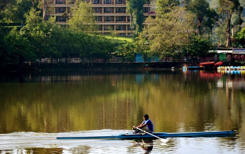 a guy with boat in green lake