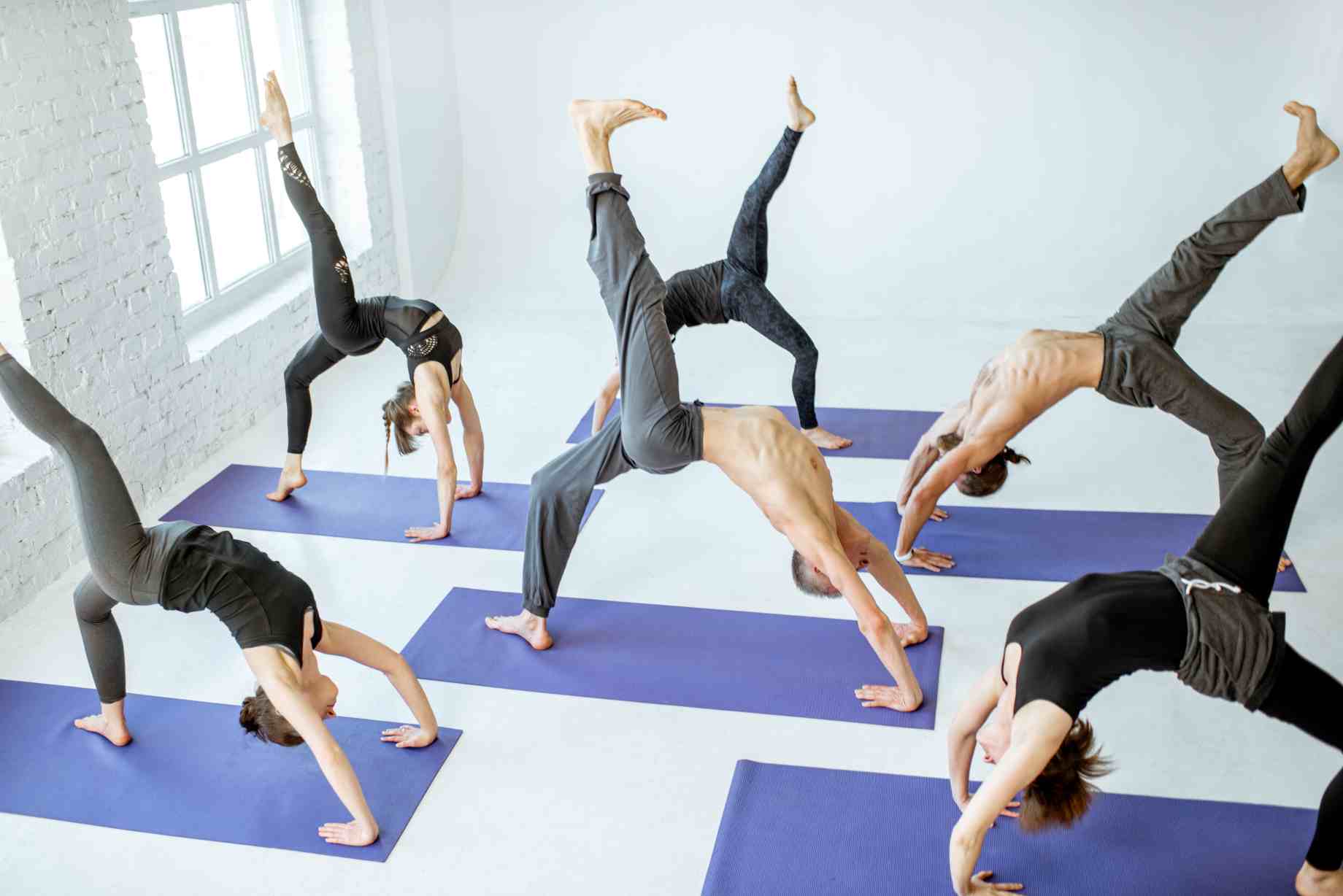 group-of-people-practising-yoga-indoor