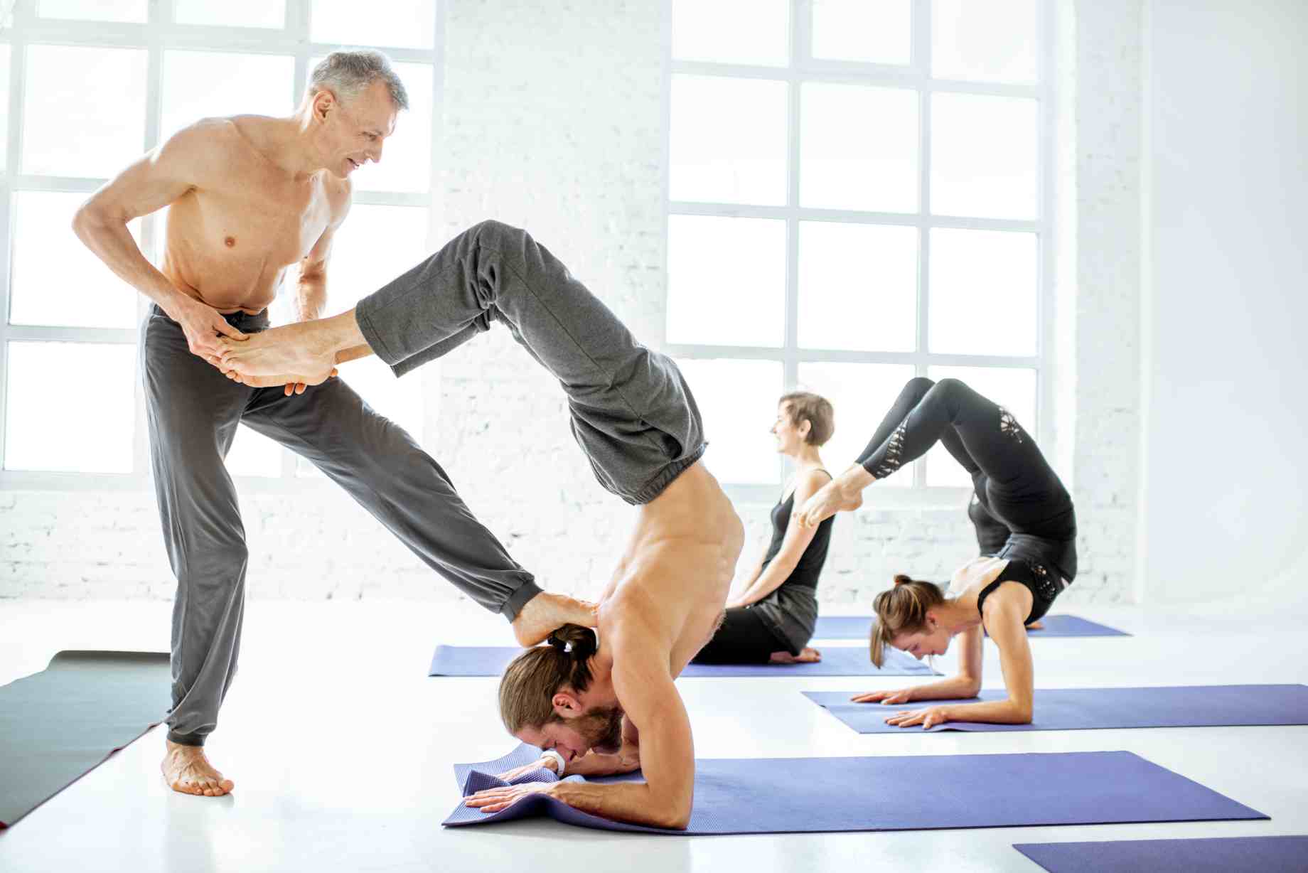 group-of-people-practising-yoga-indoors