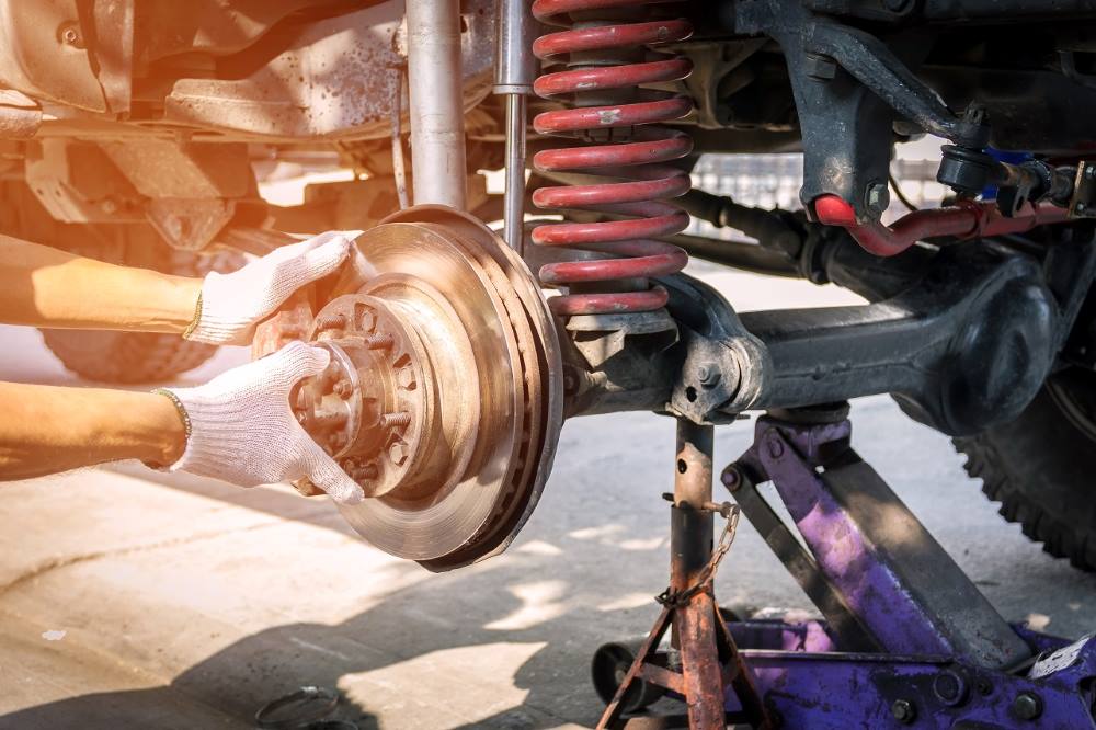 hand-technician-wearing-gloves-repairing-car-brake