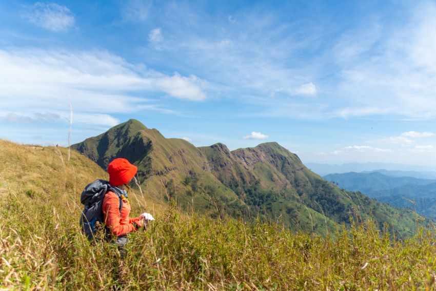 hiking woman stand on top mountain