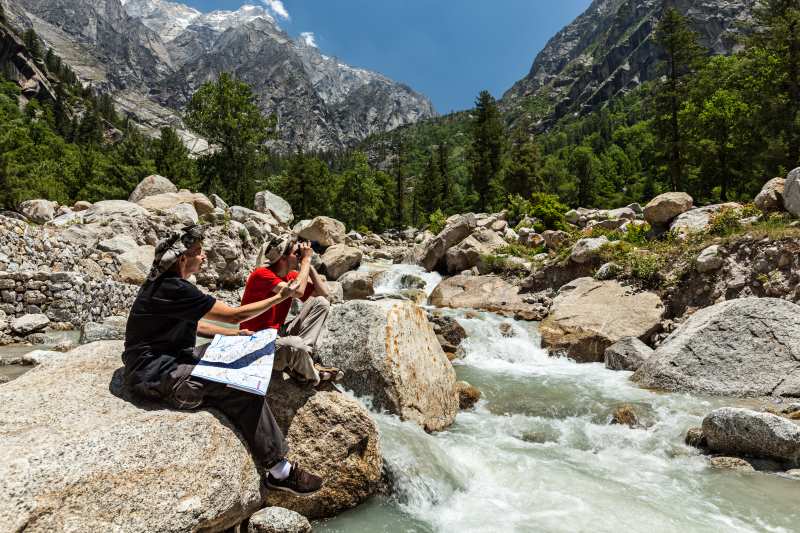 trekkers planning their trip sitiing near himalayas