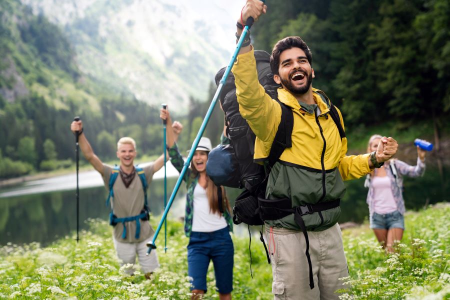 group of people trekking with happy faces