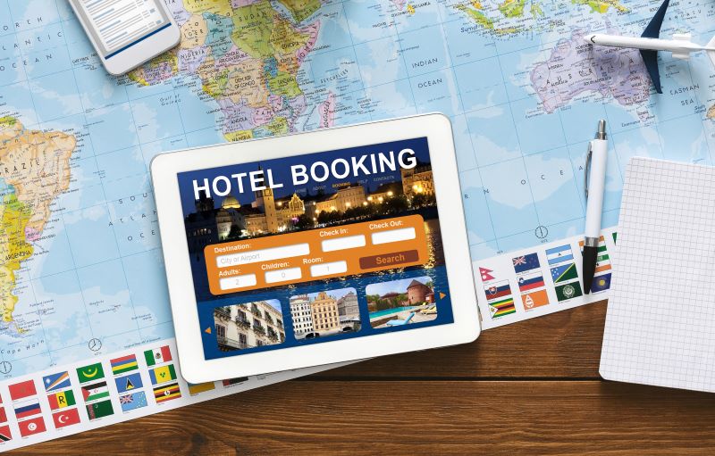 hotel booking tab and world map on table