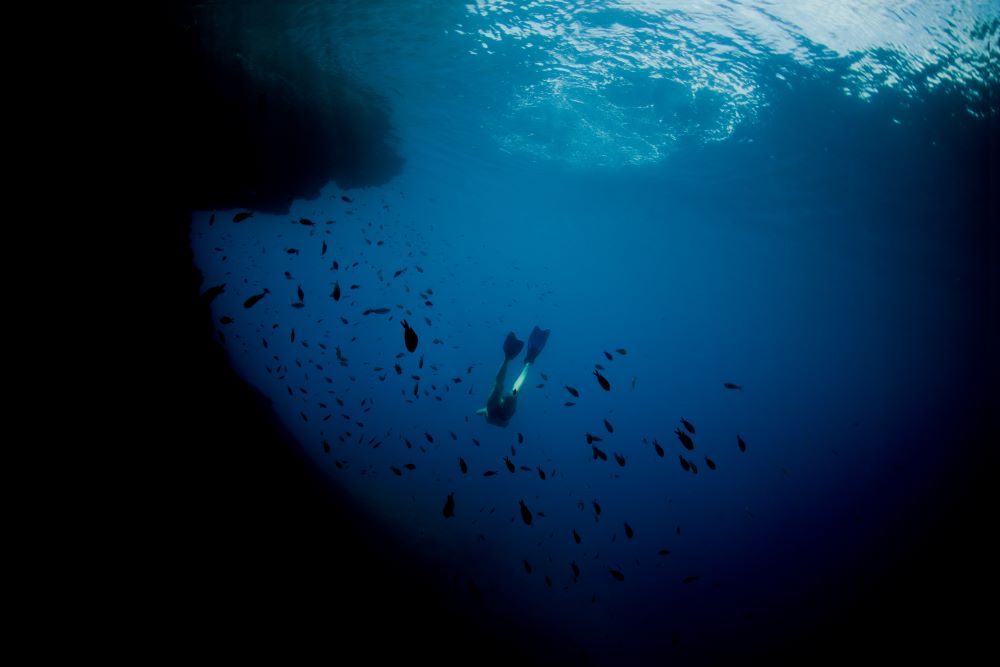 scuba diver swimming deep