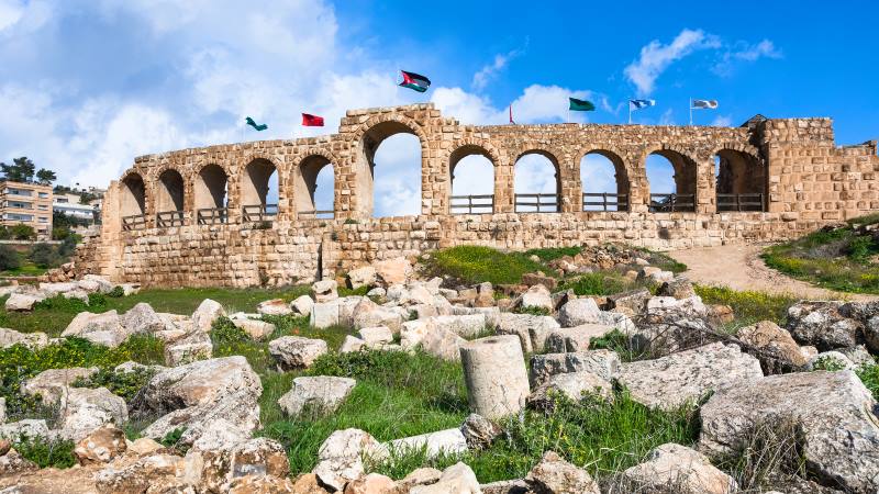 ancient jordan buidling with flags