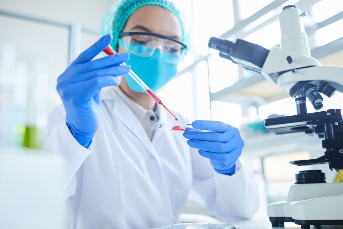 a lab worker doing a idh blood test in a laboratory