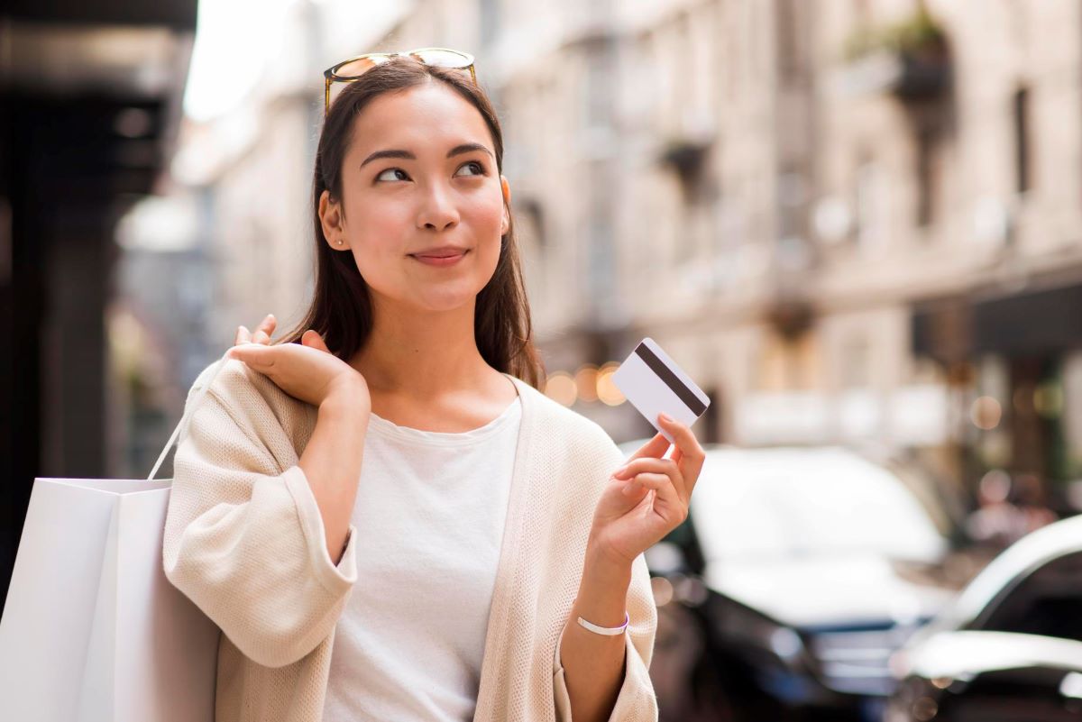 woman holding a lifestyle credit card on the hand