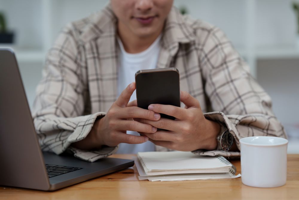 man completing kyc using his mobile phone