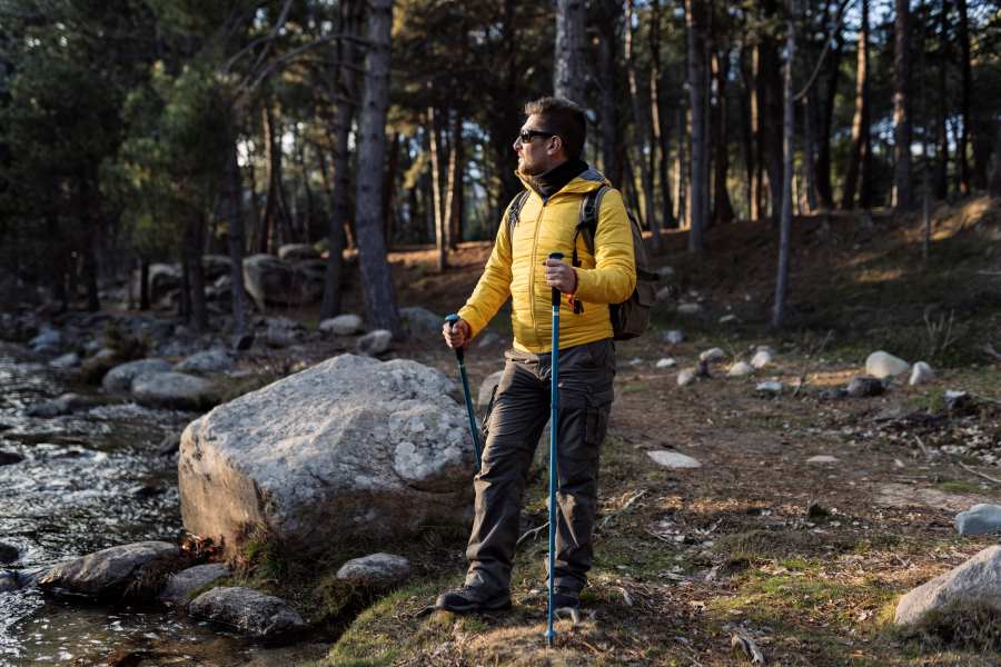 an young man trekking in the forest area of himalayas