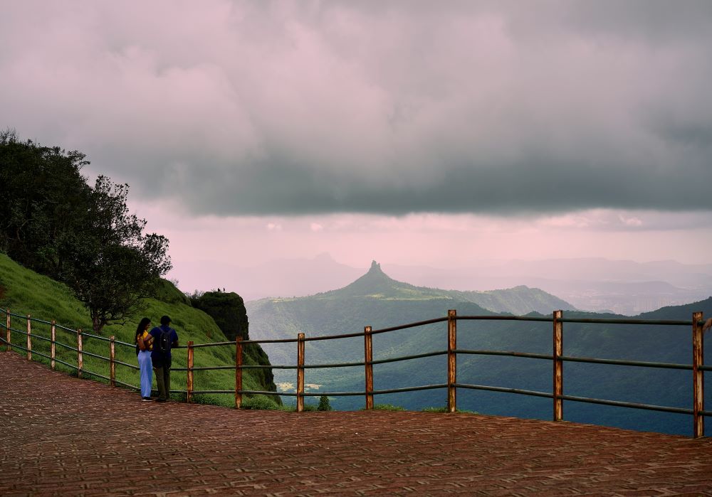 men and women looking athe view from matheran top