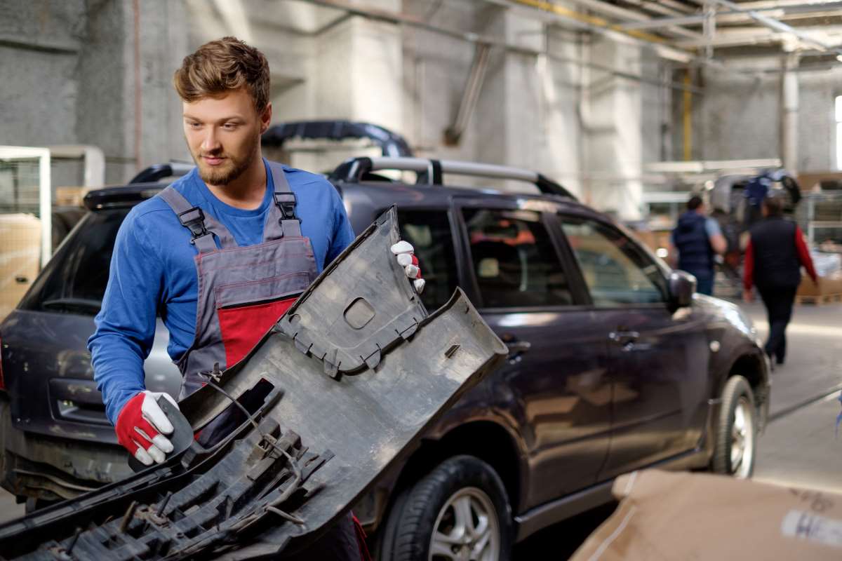 car mechanic repalcing the car bumper