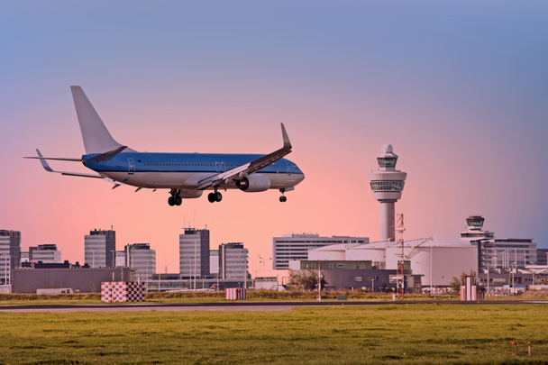 plane landing at amsterdam international airport netherlands