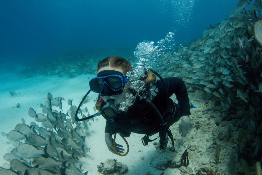 woman with scuba diving suite underwater