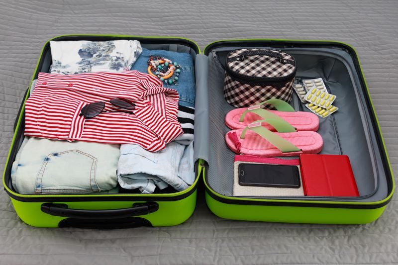 blue overfilled suitcase with clothes