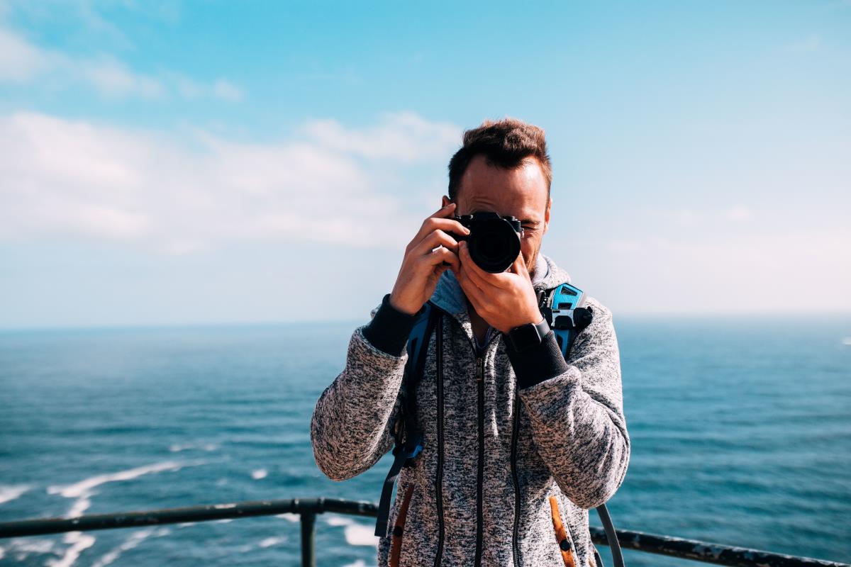 photographer taking picture in sailing boat