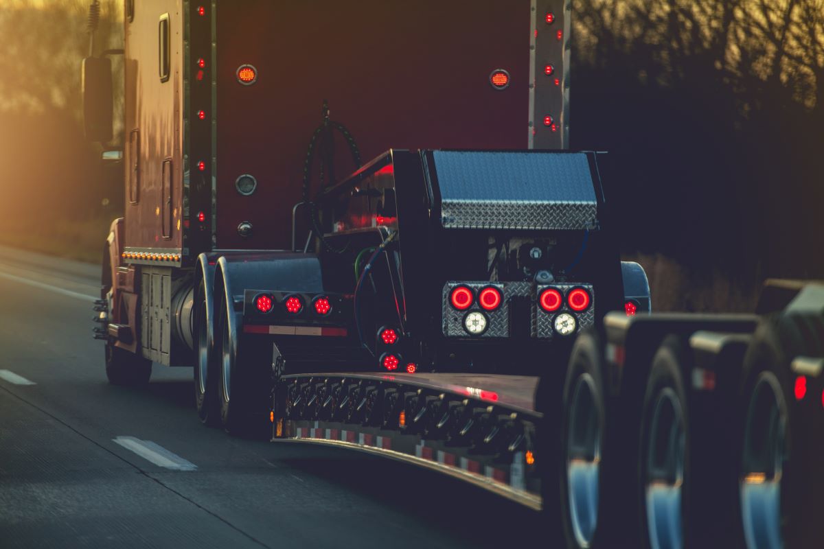 platform trailer semi trucks on a road