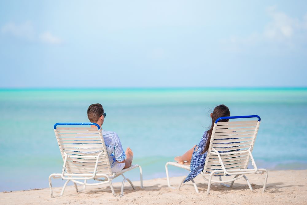 couples sitting on chair in beach