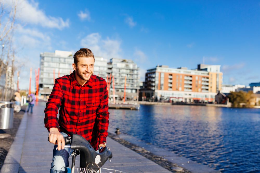 a guy cycling near water side