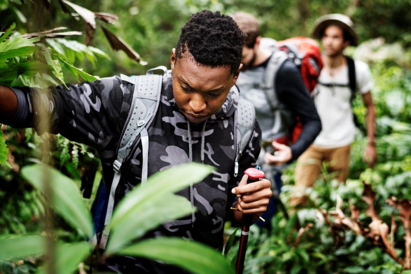 three hikers moving forward