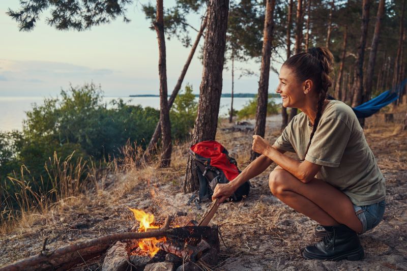 girl in jungle with wood fire