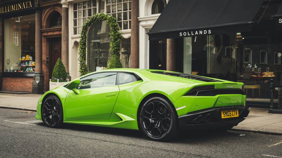 green colour supercar on the road