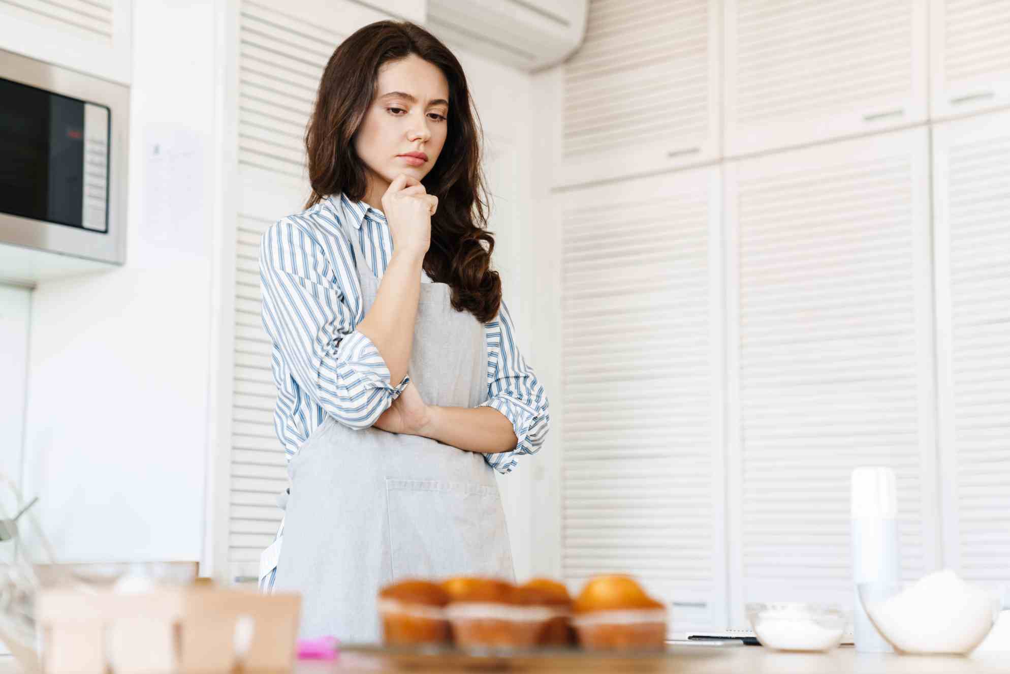 thinking-brunette-woman-wearing-apron