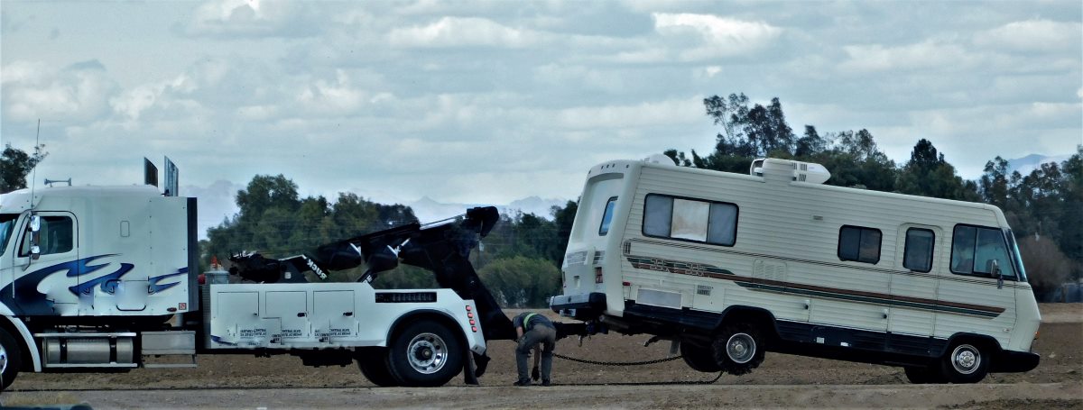 tow truck wrecker towing a motorhome