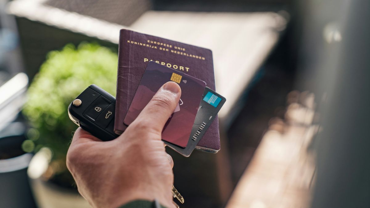 a person holding a travel credit card with passport