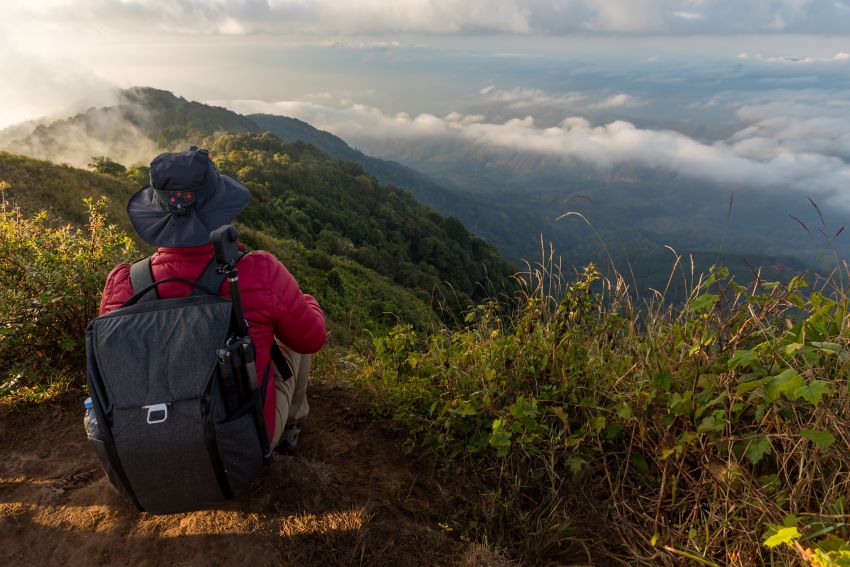 man taking rest after trekking