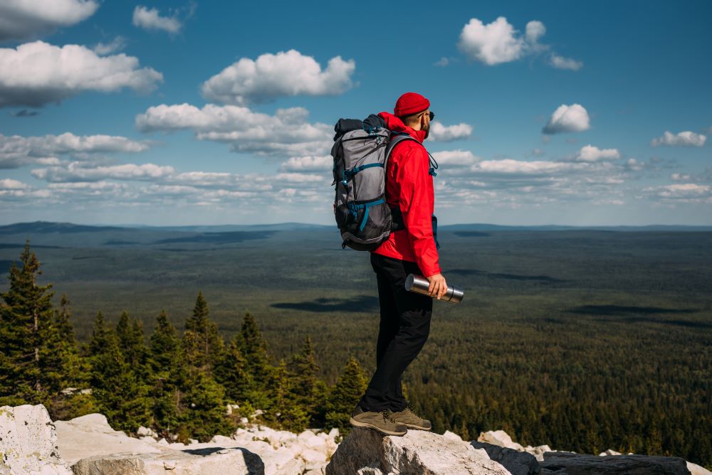 a man with red hoodies at the top of hill