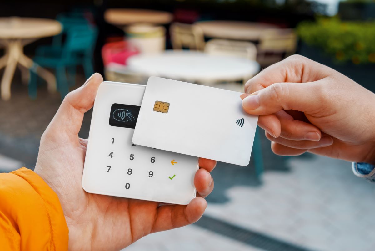 customer using a contactless credit card for making a payment in cafe