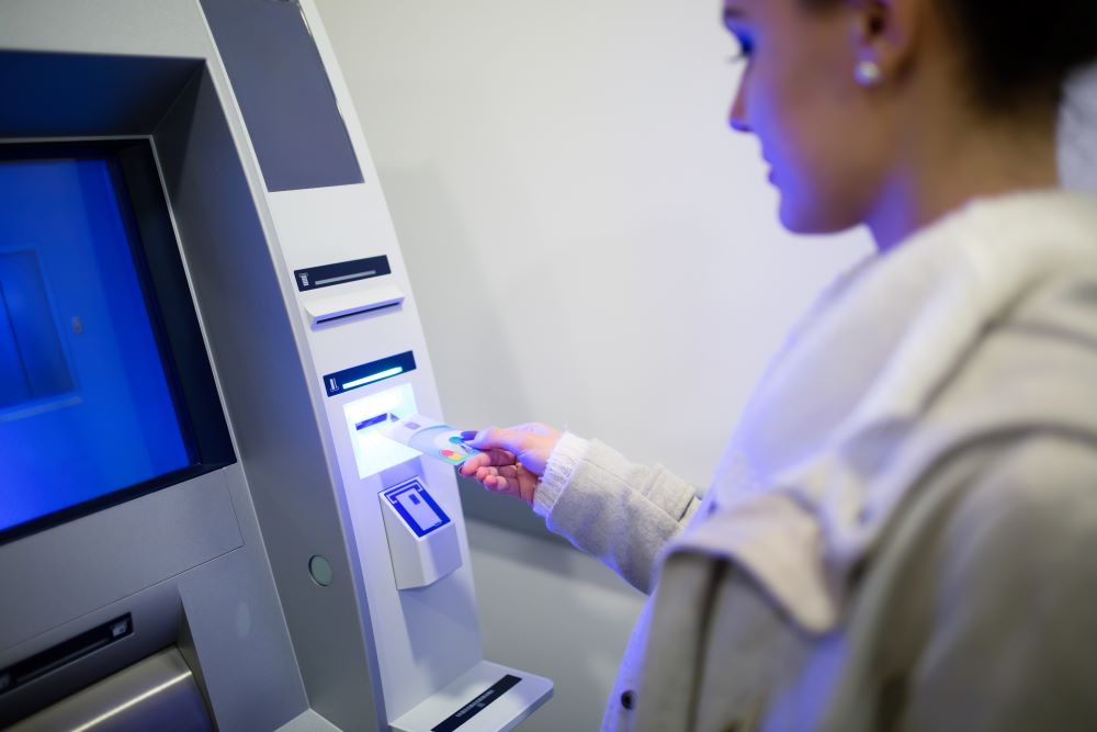 woman with atm card at atm