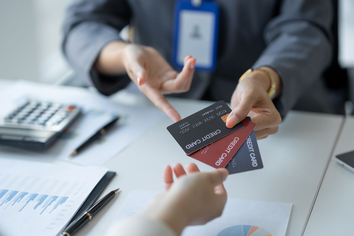 a young business woman holding credit card to check the credit limit