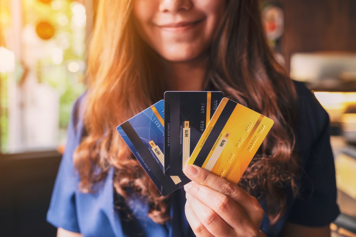 women holding multiple credit cards in hand