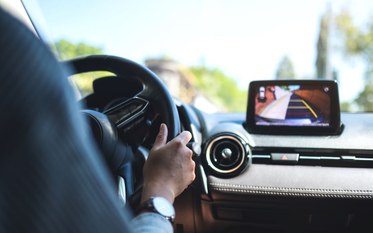 woman checking the rear camera by holding the steering